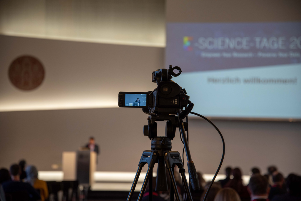 Picture of Camera in front of a presentation at the E-Science-Tage